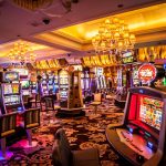 Interior view of a vibrant casino with slot machines and decorative lighting.